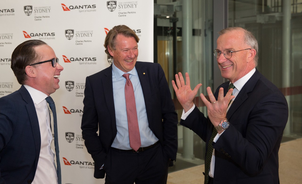 A photo of three men standing together.