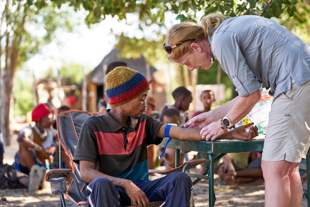 Vanessa Hayes working in Namibia, with local man, D’cao.