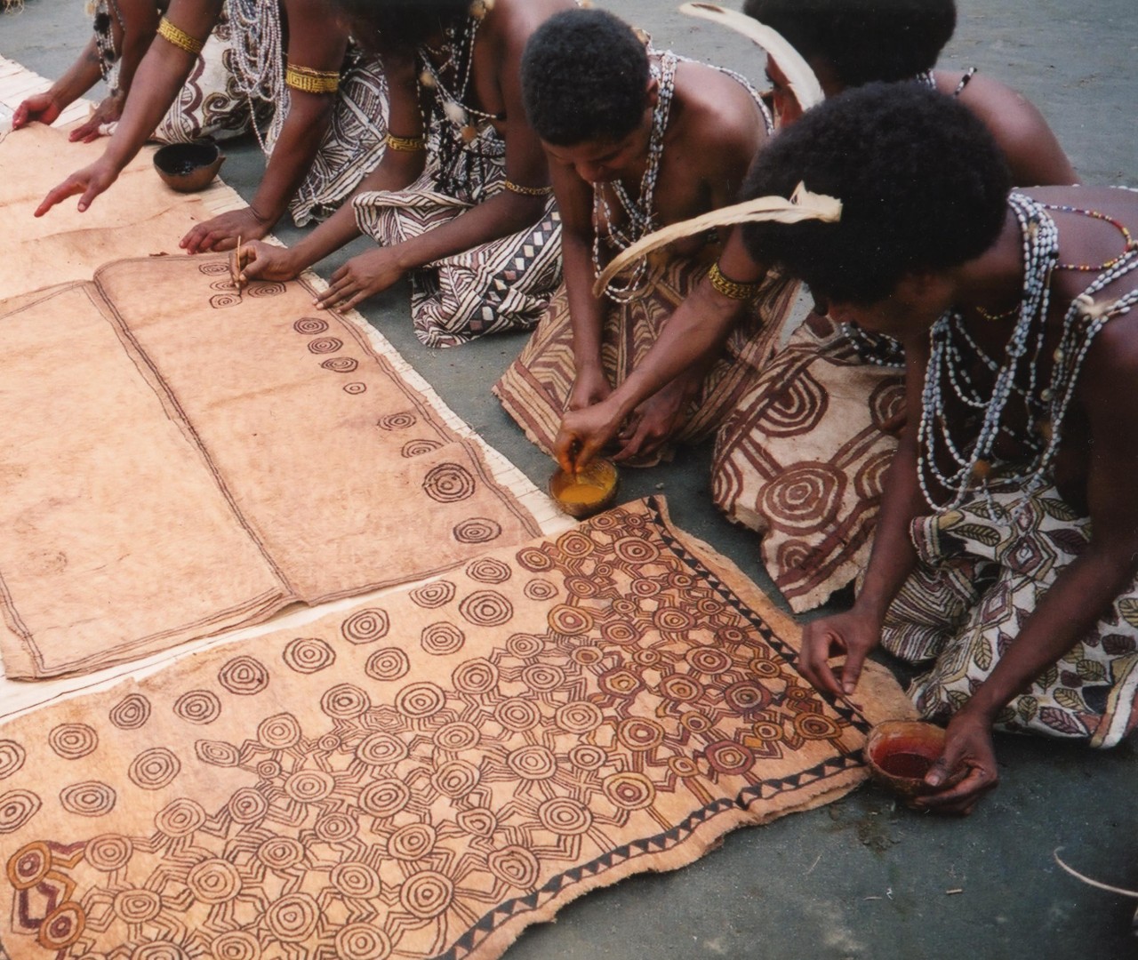 Women painting the back cloth 