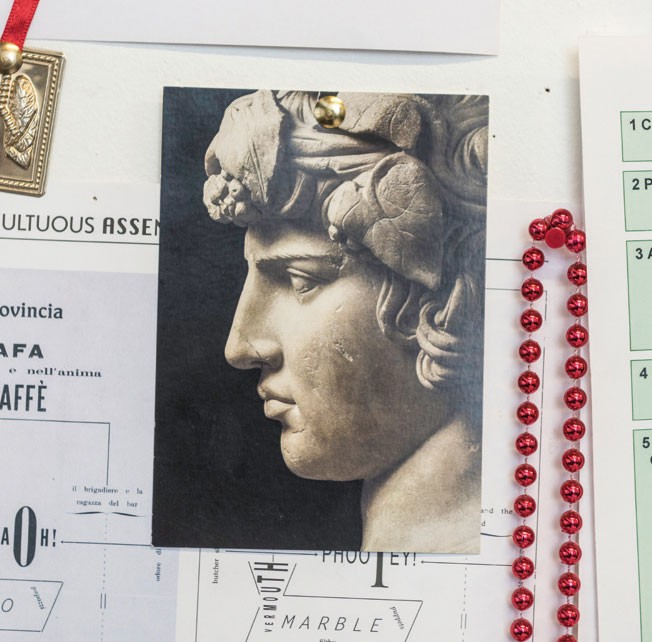 A postcard with a picture of a sculpture on the front