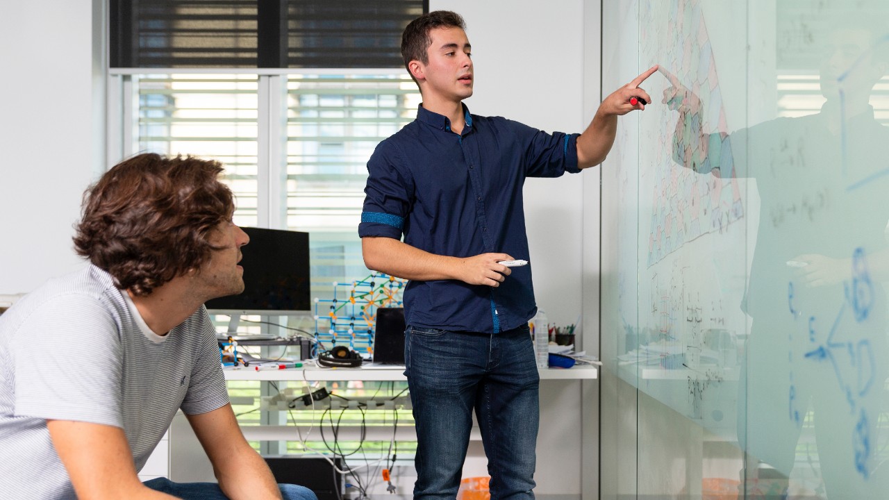 Dr Ben Brown (left with Pablo Bonilla) said building a quantum computer is like trying to get the Wright brothers' plane off the ground. We have the pieces it's just not quite flying.