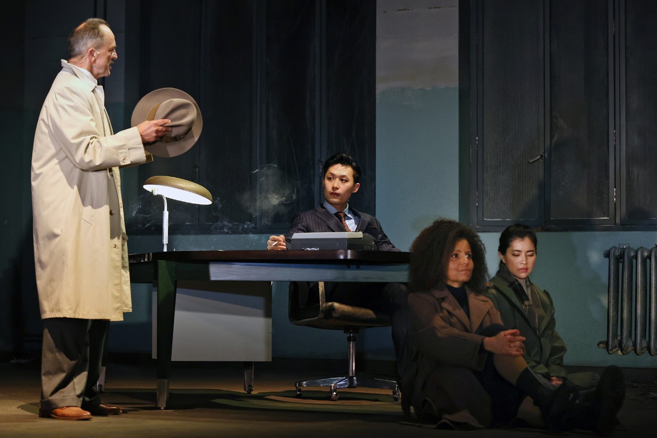 photos of actors on stage in an office setting