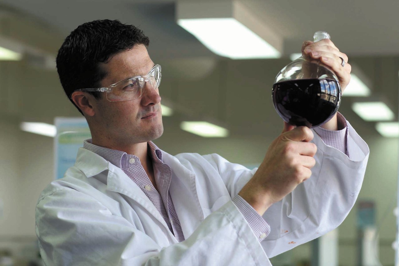 Richard Payne holds a beacon filled with liquid. 