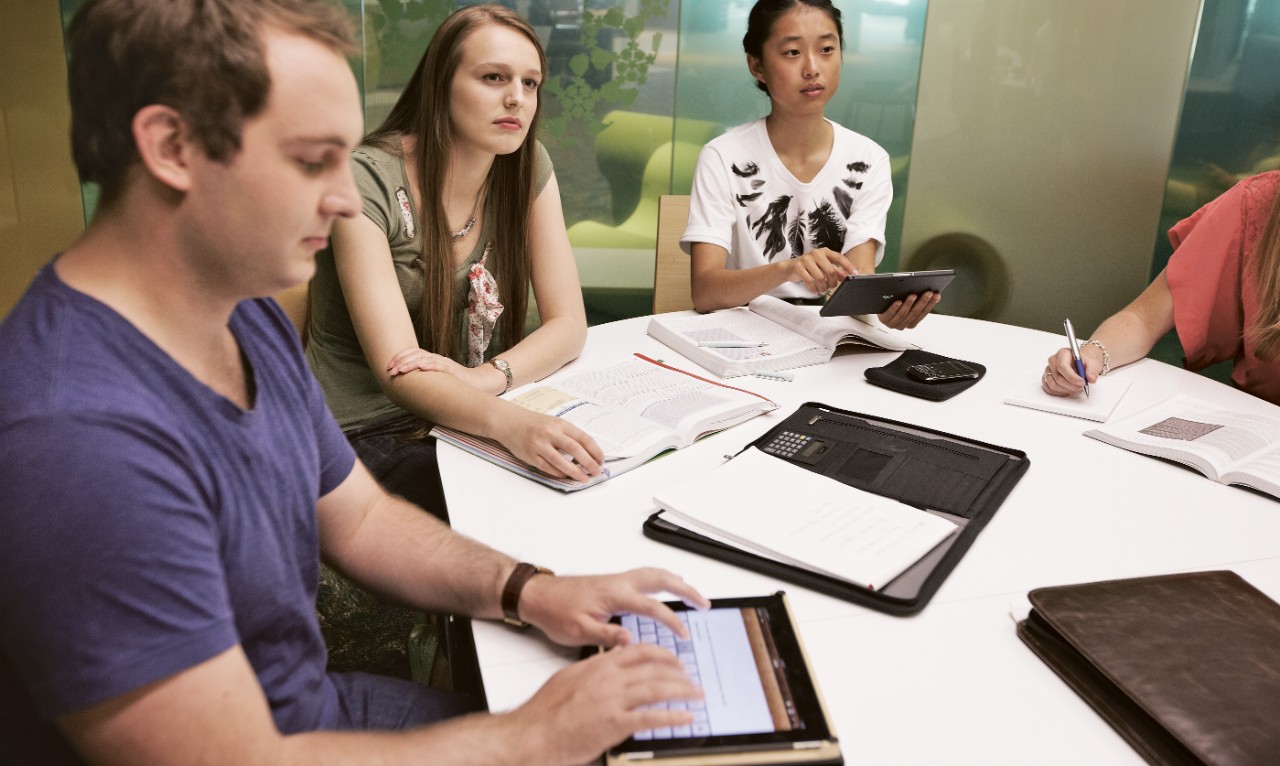 Students working collaboratively around a table.