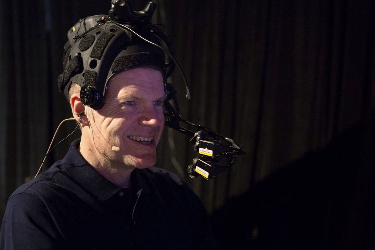 Mike Seymour wearing facial mapping technology