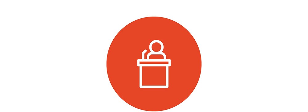 Icon of a person speaking at a lectern