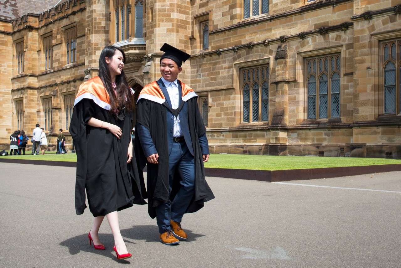 Two students in graduation gowns