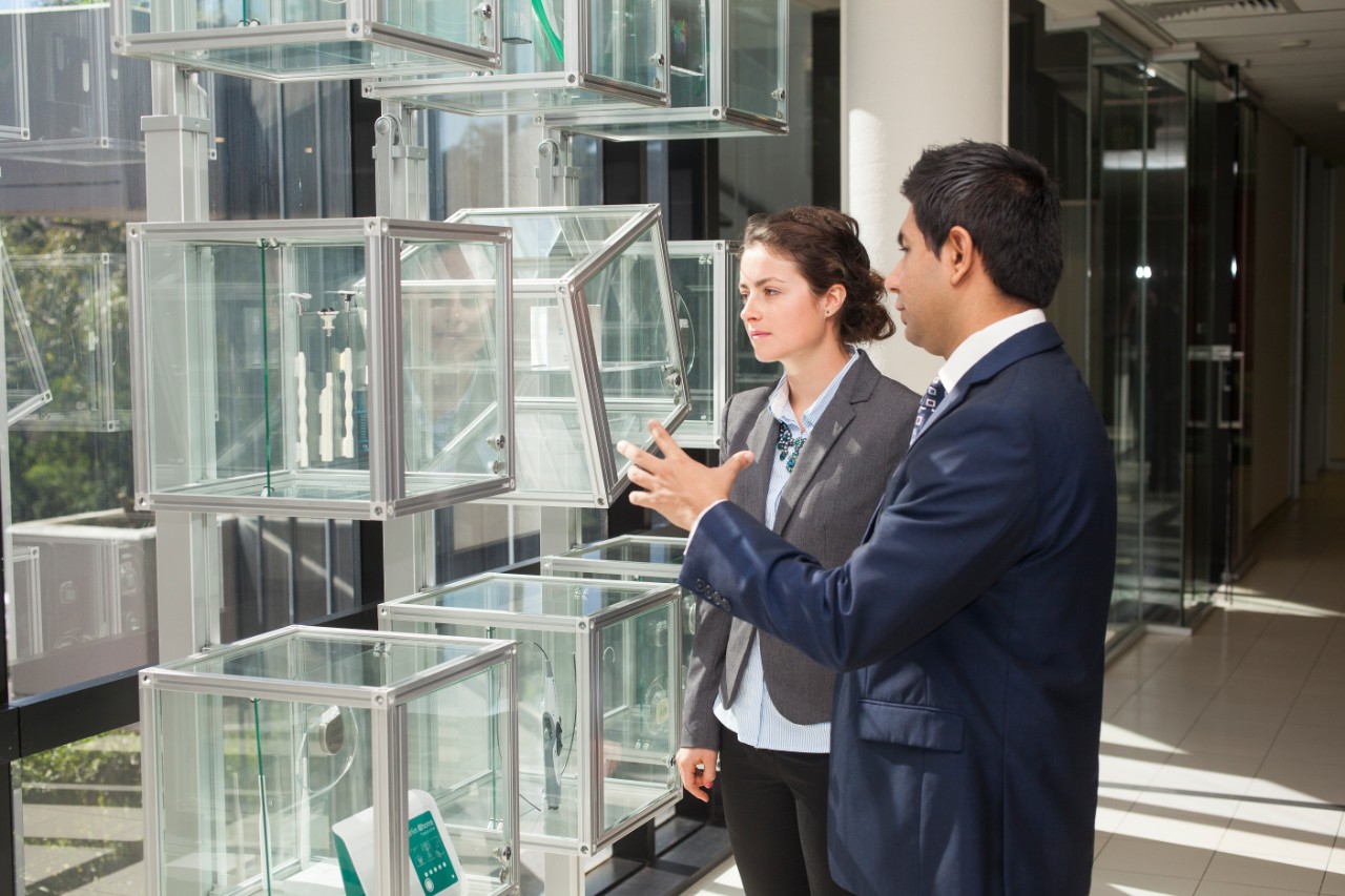 Young female and male colleague talking.
