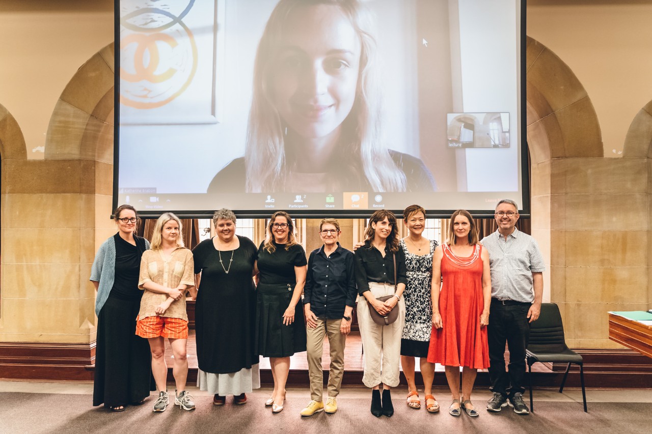 L-R: Jen Crawford, Emily Stewart, Associate Professor Kate Lilley, Melinda Bufton, Pam Brown, Mireille Juchau, Dr Beth Yahp, Claire Aman, Bernard Cohen. On screen – Katherine Brabon. Image: Talin Roche. 