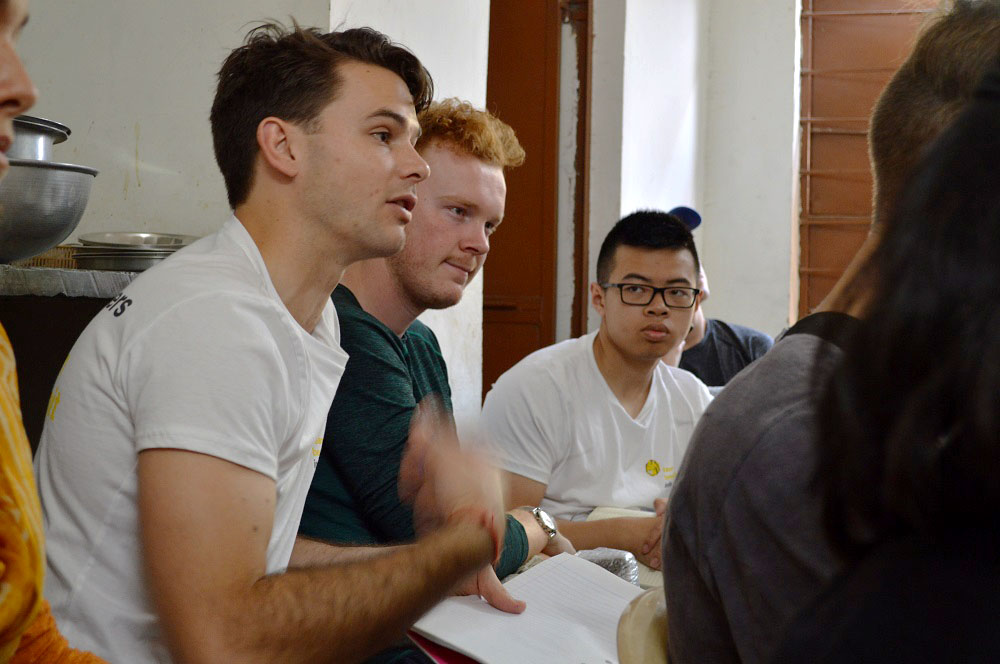 Students in a classroom participating in a discussion.