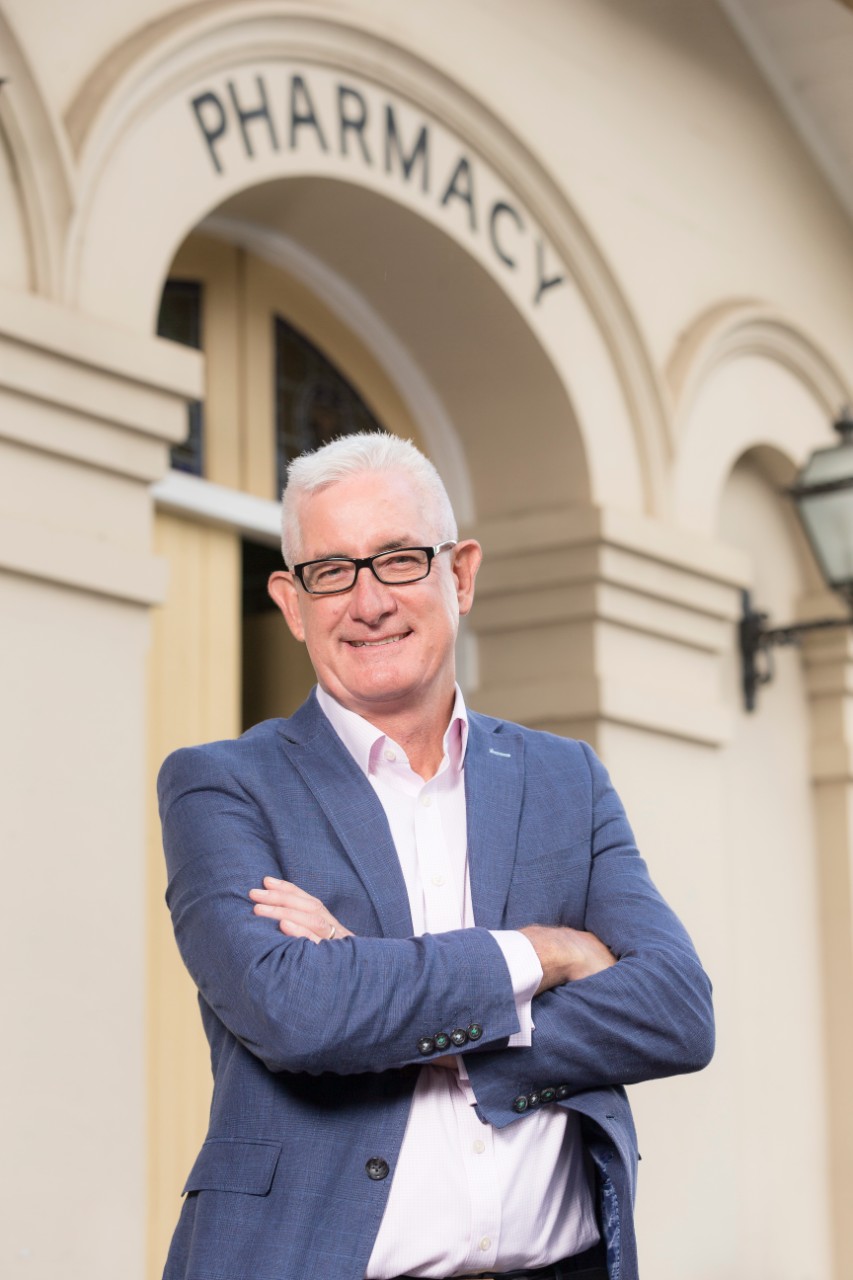Photograph of Professor Andrew McLachlan outside the pharmacy building