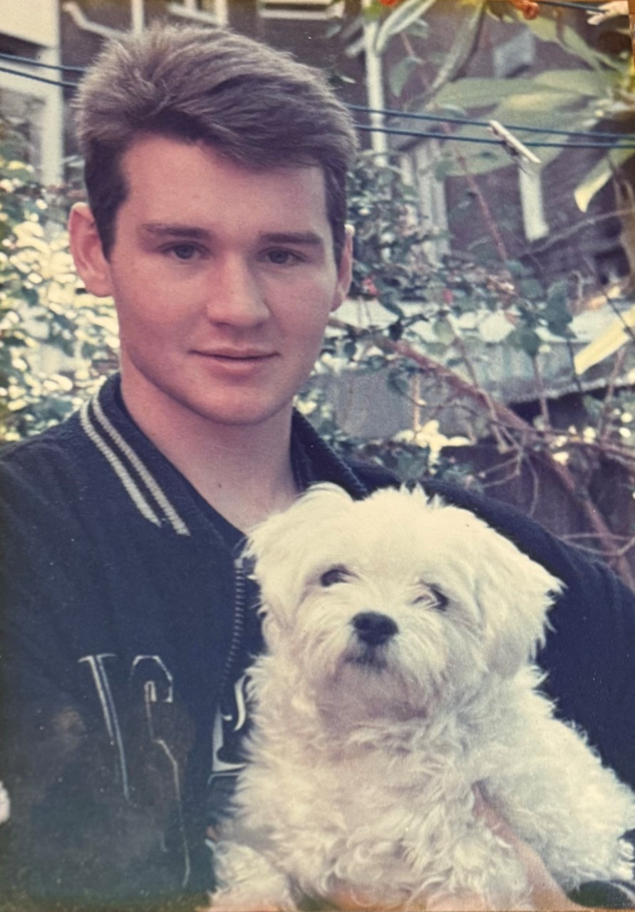 Tim Haire holding a white puppy
