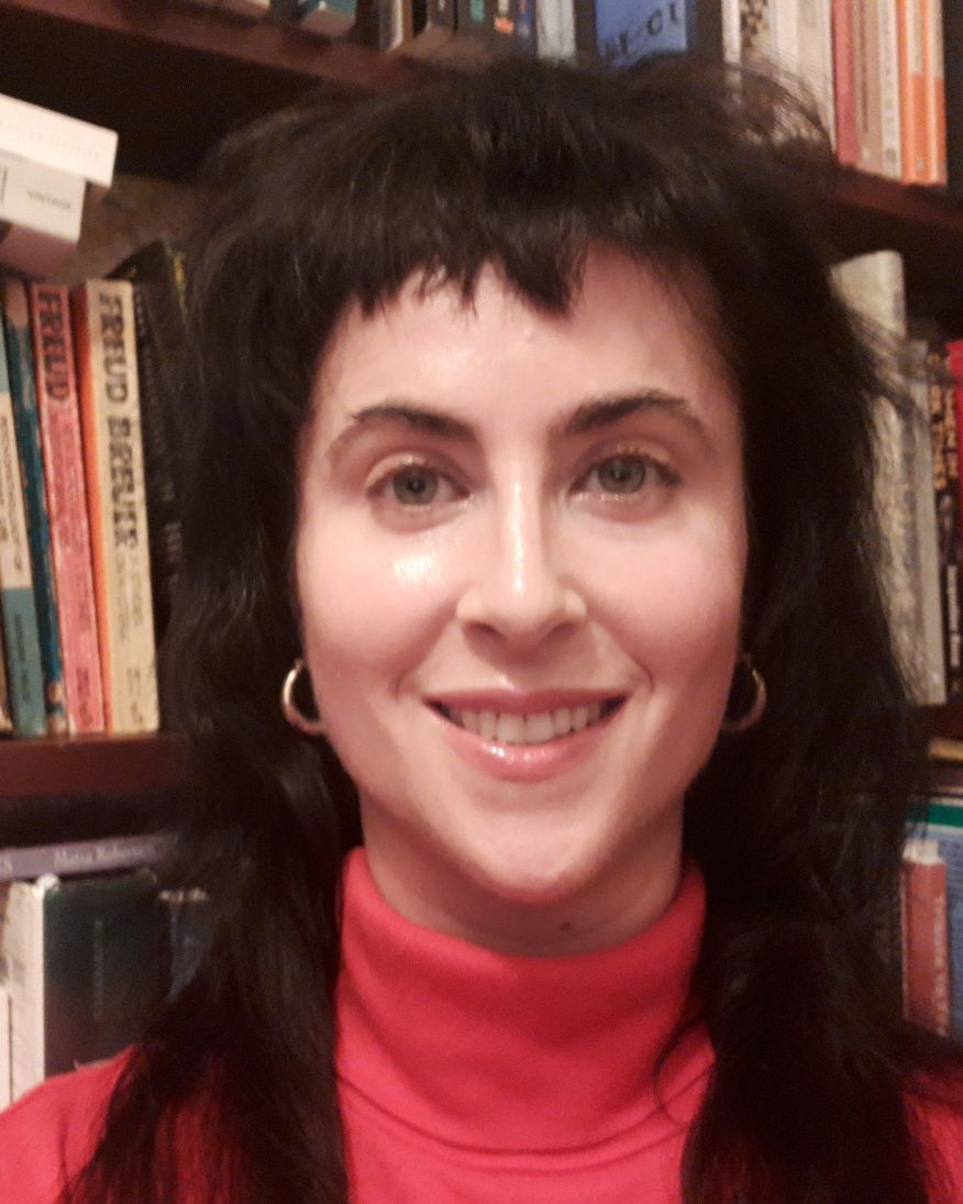 Close up image of Jacqueline Dalziell with a bookcase behind her 