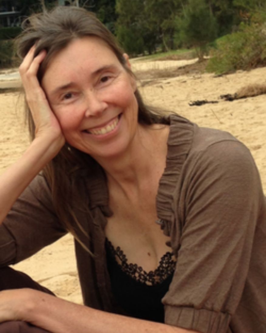 Close up image of Prof. Sigi Jöttkandt (Keynote Speaker) sitting on the beach with her head resting upon her hand. 
