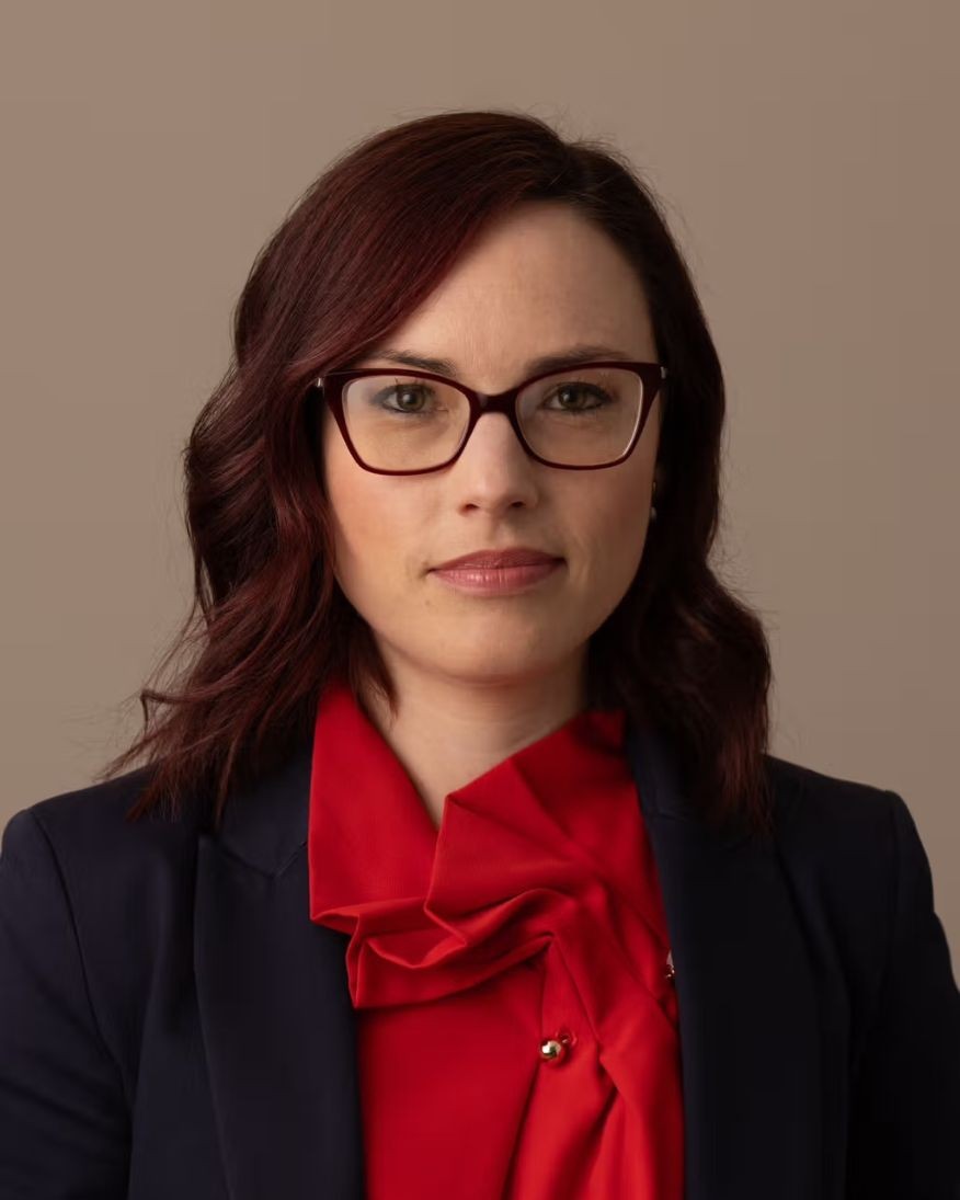 Close up image of Hayley Channer in a red top with a black blazer. 