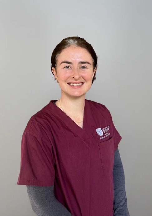 Image of Dr Genevieve Dwyer holding a small dog.