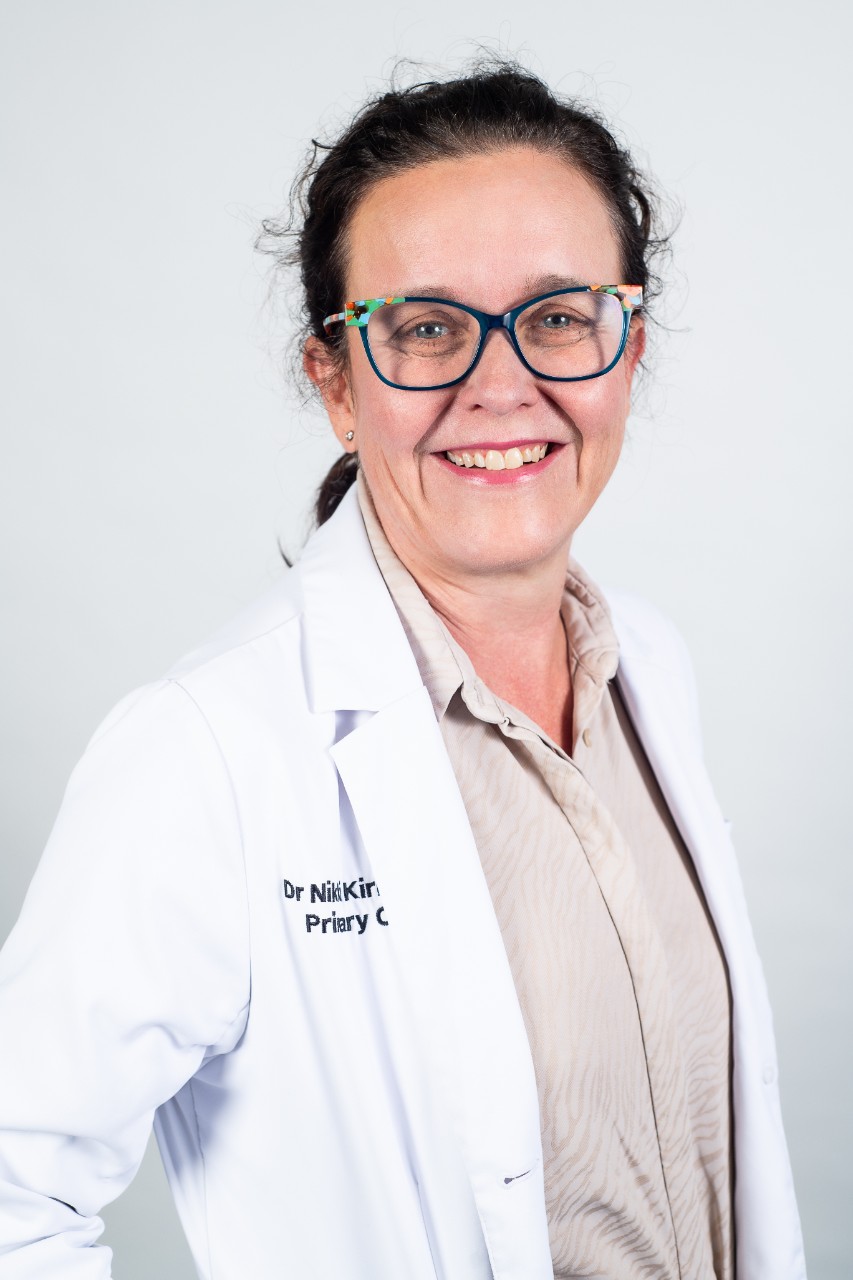 Portrait of Dr Nicolle Kirkwood in a white lab coat.