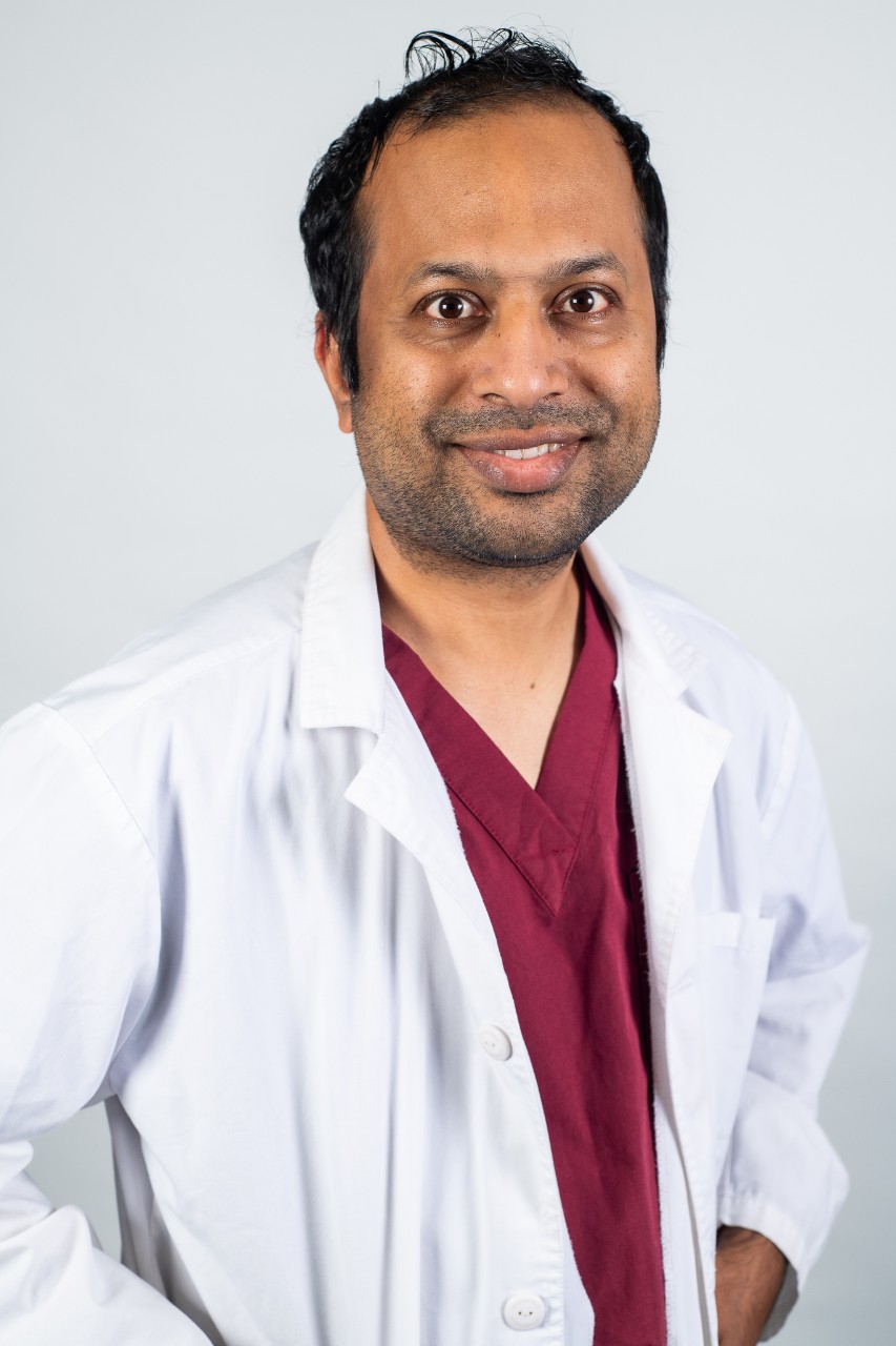 Image of Dr Sandeep Karna in a white lab coat.