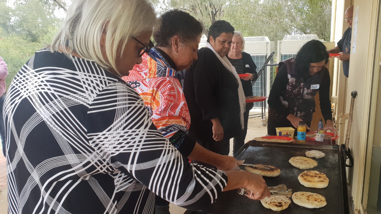 Cooking johnnycakes with native grain.