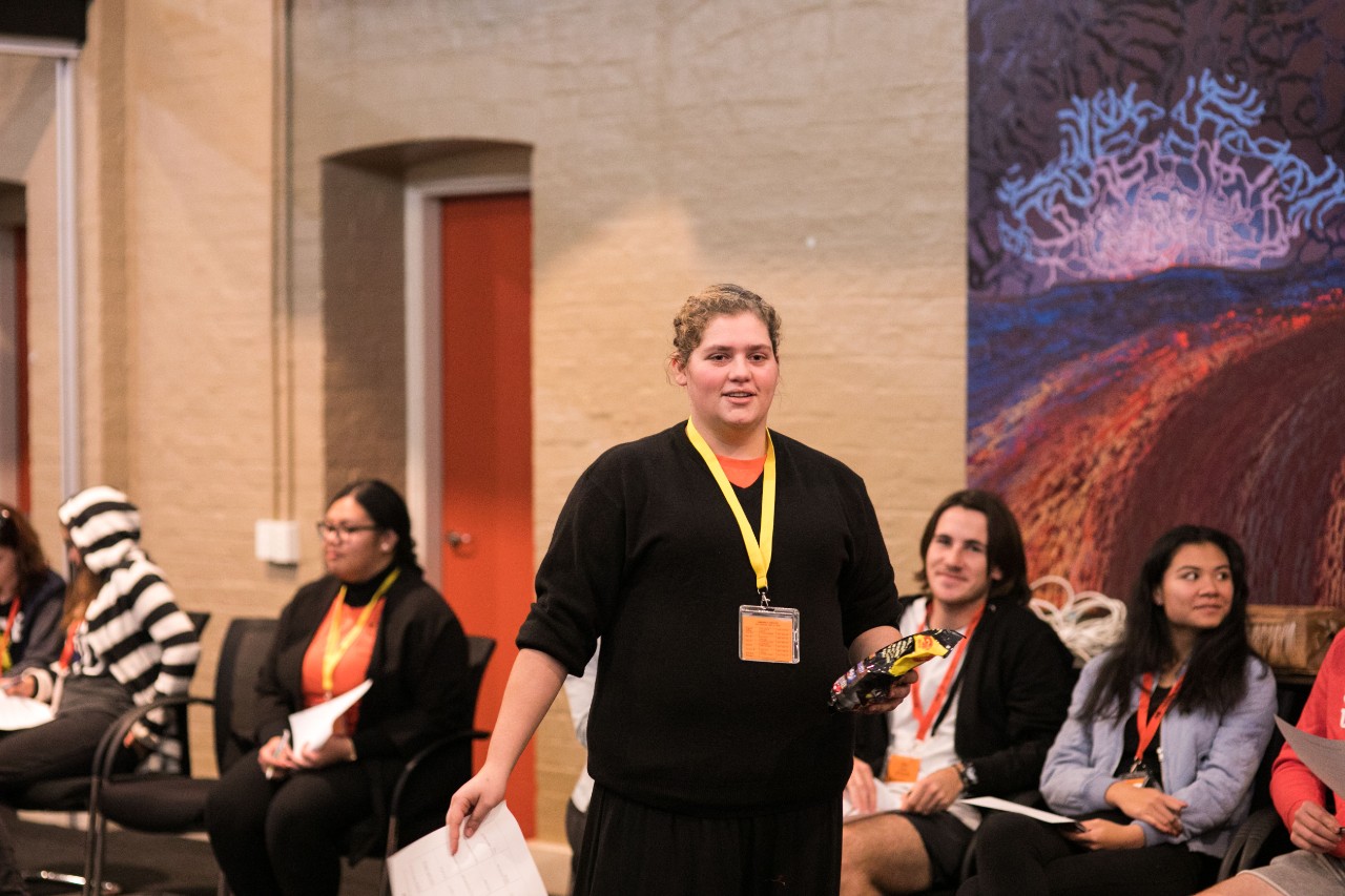 A photo of a young Aboriginal woman walking.