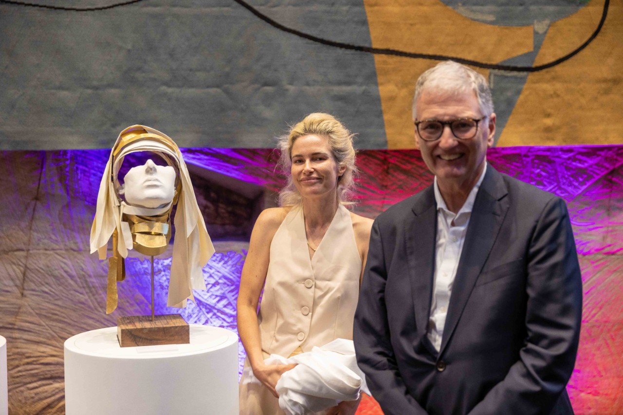 photo of a blonde woman, the artist Anna-Wili HIghfield and a man in a suit Philip Kent