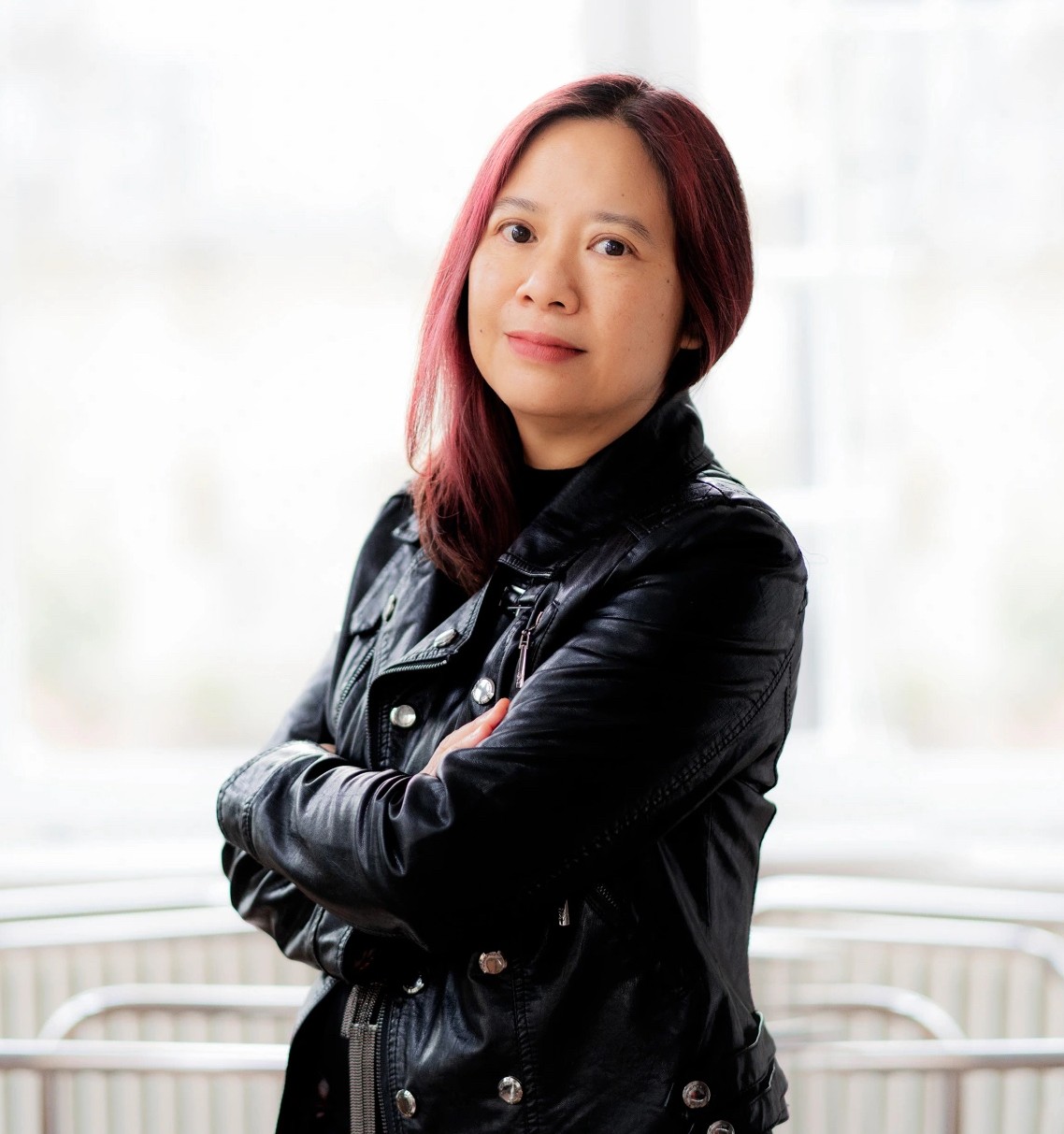 photo of composer Liza Lim with her arms crossed and smiling