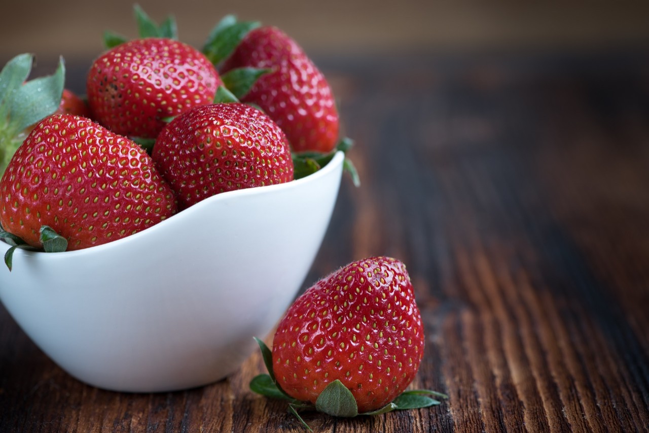 Photo of a small jar full of strawberries