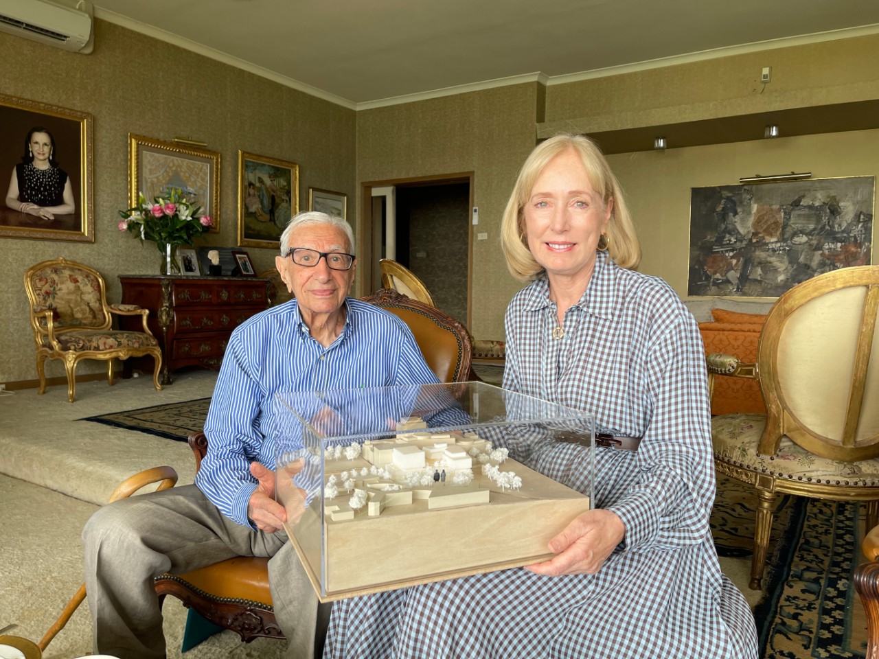 Isaac Wakil AO and Chancellor Belinda Hutchinson  seated in room with model