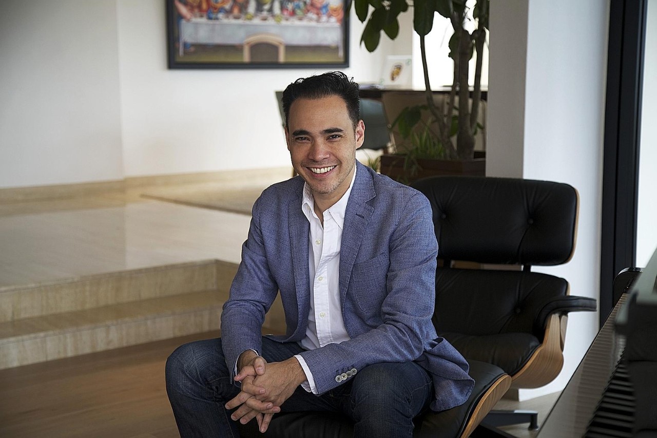 Patrick Y Grove sitting in a chair 