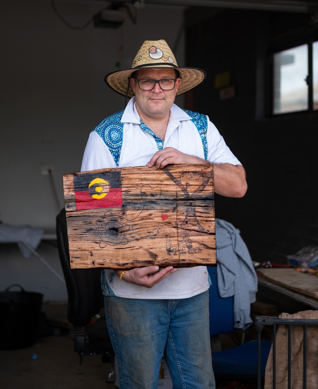 rofessor John Gilroy holds his work The Head And Hands Need The Heart