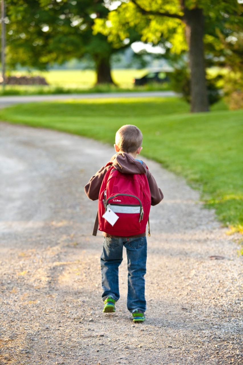 Child carrying large backpack