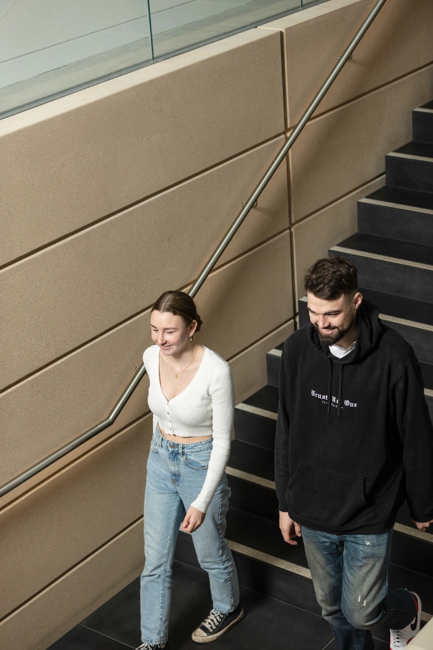 Cody and Brianna walking together down a flight of stairs