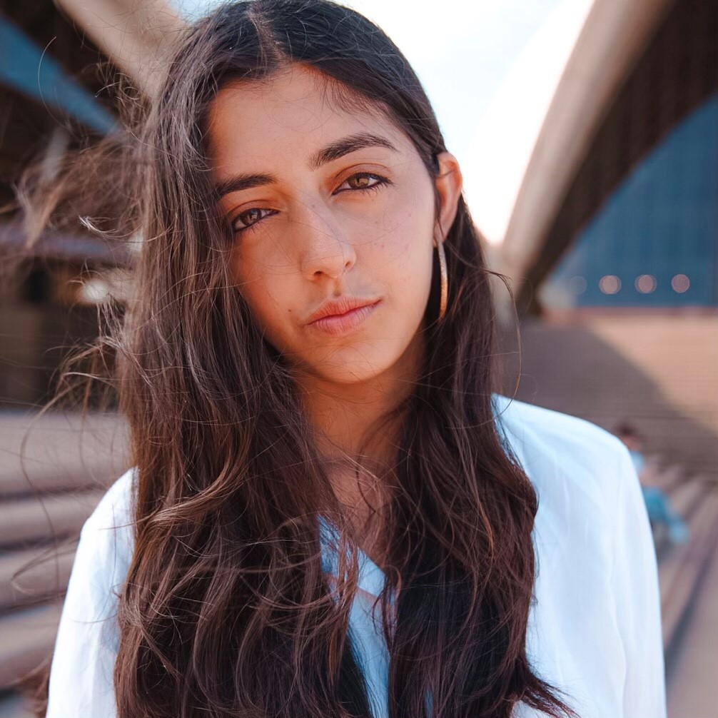 Close up of Sarea Bhar's face as she stands outside the Sydney Opera House