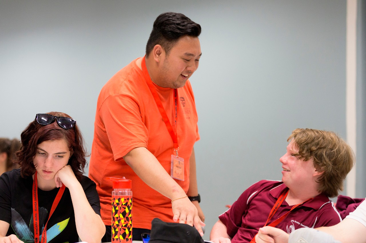 A photo of students and a teacher in a class.