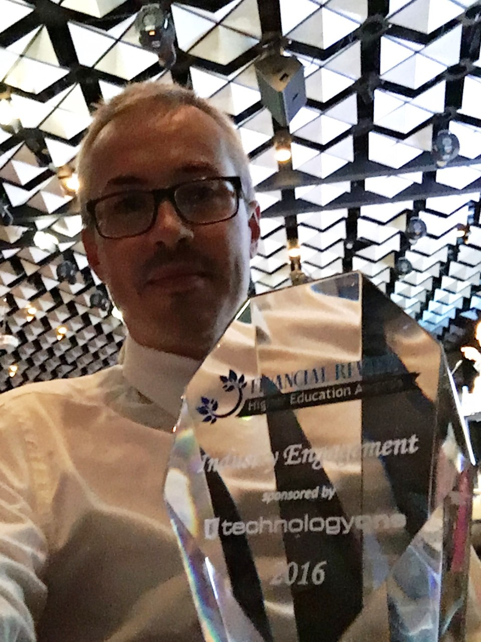 A photo of Dr Steven Scheding with the trophy.