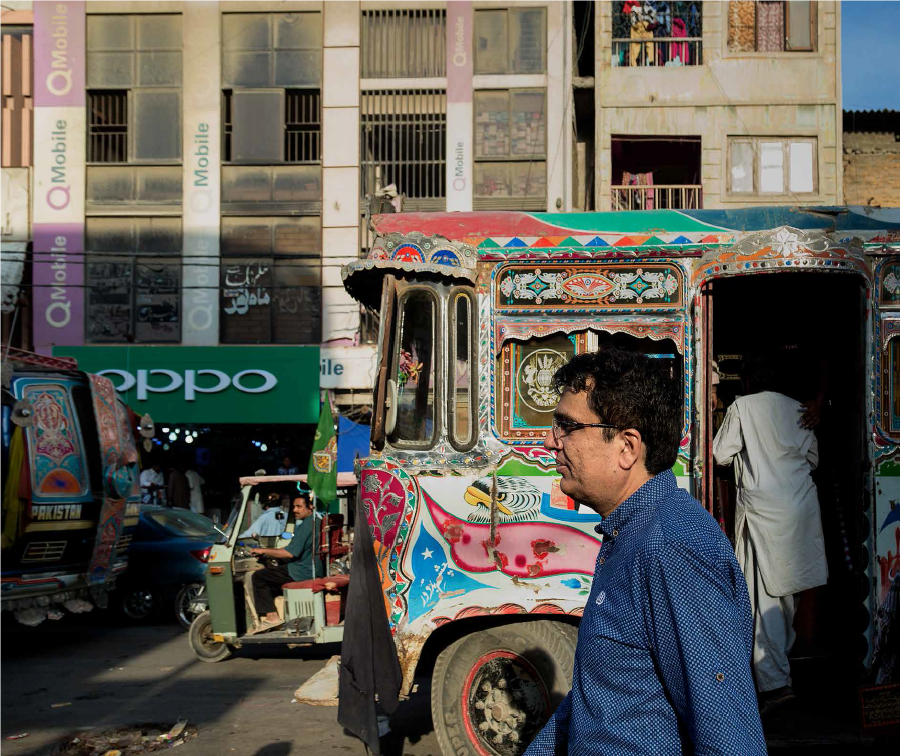 Lila Ram walking down a street in Pakistan