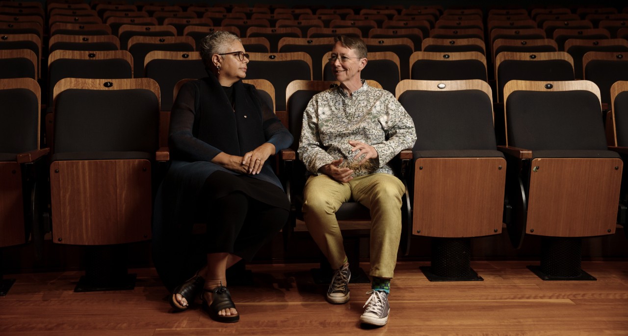Deborah Cheetham Fraillon and Anna Reid sitting in theatre seats together at Sydney Conservatorium of Music